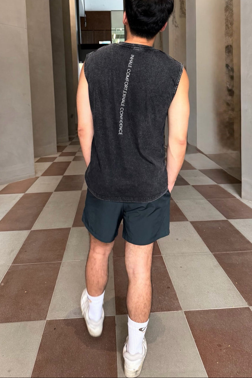 Person walking through a modern architectural hallway with checkered floor.