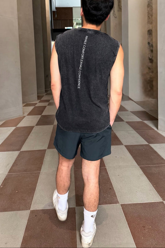 Person walking through a modern architectural hallway with checkered floor.